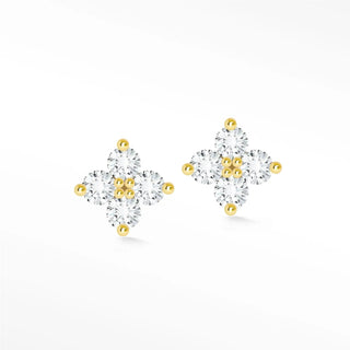 Delicate clover diamond stud earrings with clear cubic zirconia stones and gold-tone metal featuring tiny golden spheres