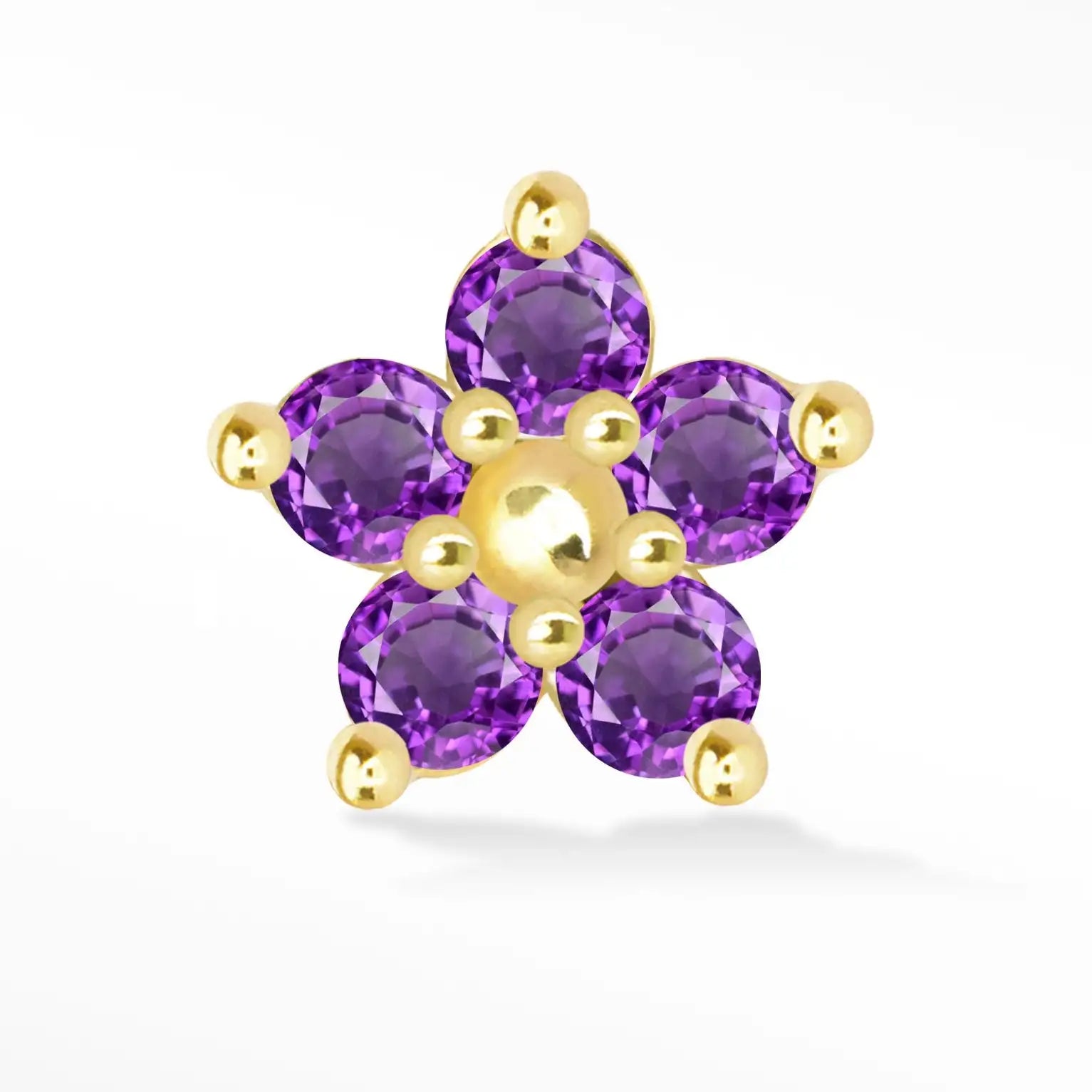 A delicate five-petal flower-shaped nose piercing featuring vibrant purple amethyst stones set in polished gold-toned metal.
