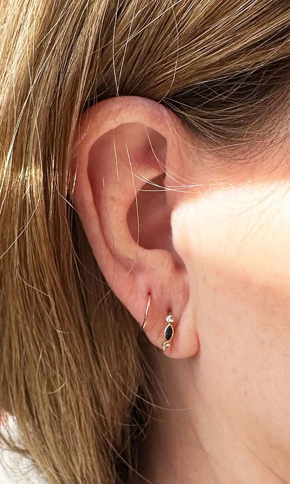 Black gemstone and gold piercing jewelry styling
