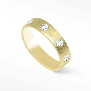A sleek gold diamond cigar band ring 14k gold with five round-cut diamonds set on a textured band ring 14k