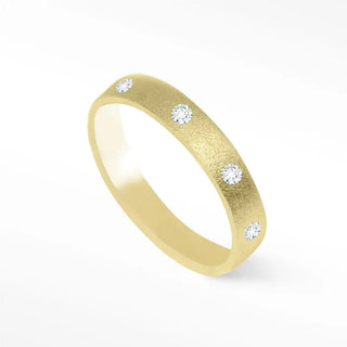 A sleek 18k yellow gold diamond cigar band ring with textured surface and four round-cut diamonds
