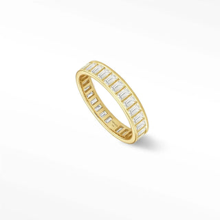 A sleek quinn diamond eternity ring in 14k yellow gold featuring a continuous row of emerald-cut diamonds