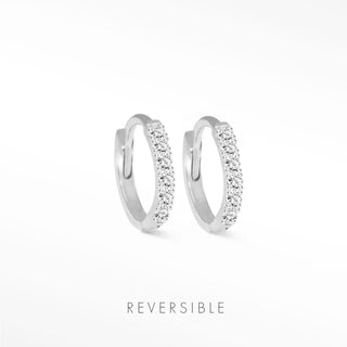 A pair of silver-toned diamond hoop earrings in 14k white gold featuring sparkling clear crystals by natalie wynning