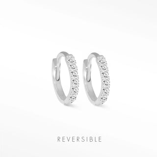 A pair of silver-toned diamond hoop earrings in 14k white gold featuring sparkling clear crystals by natalie wynning