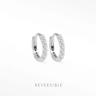 A pair of silver-toned diamond hoop earrings in 14k white gold with sparkling clear crystals from Natalie Wynning