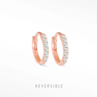 Diamond hoop earrings in 14k rose gold huggie style adorned with a row of sparkling clear stones by natalie wynning