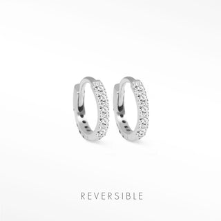 A pair of silver-toned diamond hoop earrings in 14k white gold with sparkling clear crystals from Natalie Wynning