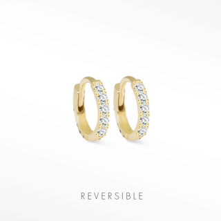 Gold-colored 14k yellow gold huggie earrings adorned with clear sparkling stones diamond huggie earrings