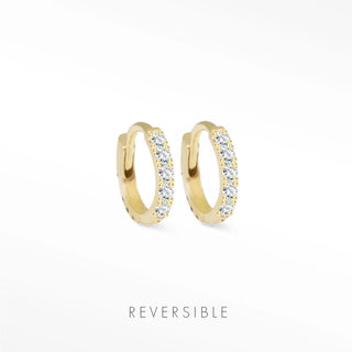 Gold-colored 14k yellow gold huggie earrings adorned with clear sparkling stones diamond huggie earrings
