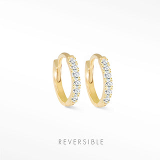 Diamond huggie earrings in 14k yellow gold featuring a row of sparkling clear stones by natalie wynning reversible hoops