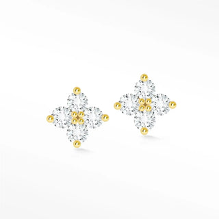 Delicate clover diamond stud earrings with clear cubic zirconia stones and gold-tone metal featuring tiny golden spheres