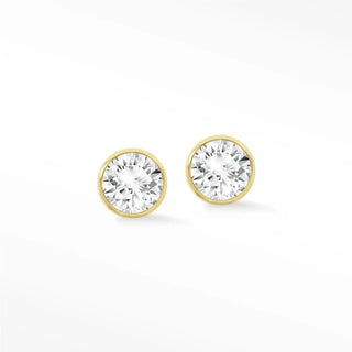 Gold-toned 14k gold bezel diamond stud earrings featuring round clear faceted stones in a simple design