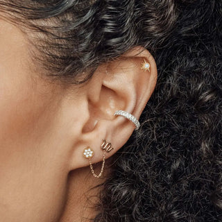 Gold star-shaped 14k yellow diamond stud earrings flat with sparkling cubic zirconia stones from The Wynning Studs