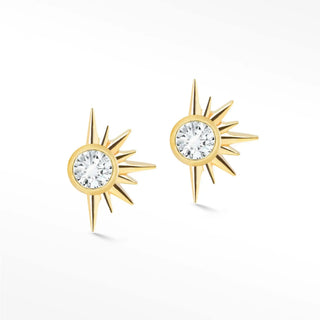 Gold sunburst diamond stud earrings in 14k gold featuring a central clear gemstone surrounded by radiating rays