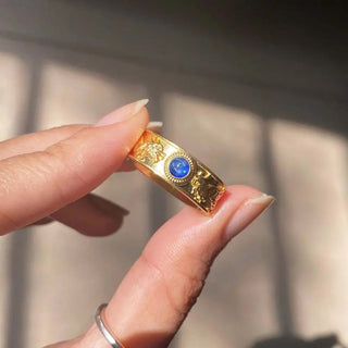 Gold band dragon phoenix sapphire ring with intricate lion head engravings and central round blue gemstone elegant ring