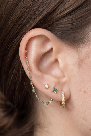 Ear chain by nina wynn. The rock candy collection features timeless natural faceted emerald round beads elegantly