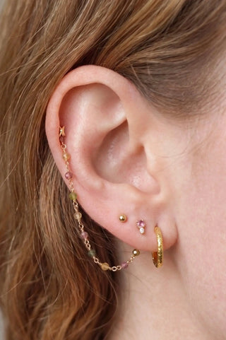 Ear chain handcrafted by nina wynn. The rock candy collection features a vibrant rainbow of natural faceted multi