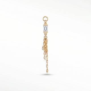 Ear charm in 14k gold featuring a fiery moissanite baguette & liquid chains. Engineered loop fits hoops studs and flat
