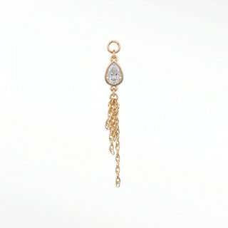 Ear charm crafted in solid 14k gold featuring a 6x4mm pear bezel-set moissanite and dangling multi-strand rope chain.