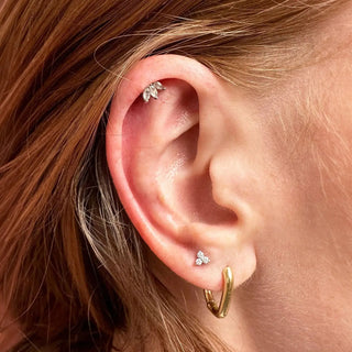 A delicate silver leaf-shaped stud earring with clear crystals by jewelry designer nina wynn at ear spa denver