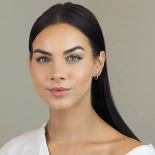 Ellie diamond gold hoop earrings featuring a 14k yellow gold reversible huggie with a black accent stone 13mm