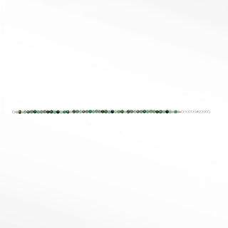 Emerald gemstone beads close-up; metal fittings are outside the crop