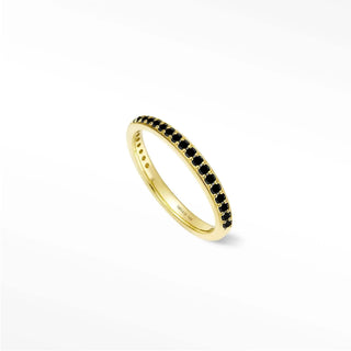 A delicate 14k gold eternity ring black diamond band with a continuous line of small round black gemstones