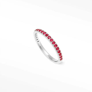 A sleek silver eternity rings ruby band featuring vibrant red rubies set in the thea 14k gold channel