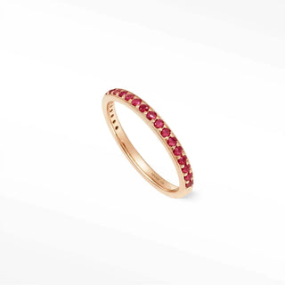 A delicate rose gold eternity rings ruby featuring a continuous line of vibrant red rubies in thea 14k gold band