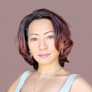 Professional piercer at Nina Wynn performing precision ear piercing in Denver