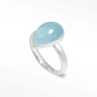 A delicate aquamarine silver ring with a smooth light blue teardrop stone from the fairy dust aquamarine collection