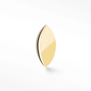 A sleek flat back 14k gold marquise lens with smooth curved surface and reflective highlights from the wynning studs