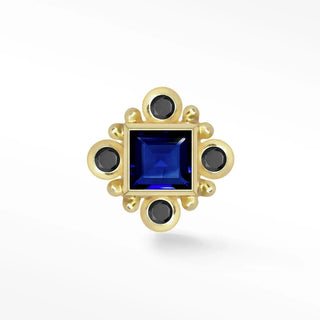 A gold-toned flat back earring with blue sapphire and black onyx in hypoallergenic 14k gold ornate design