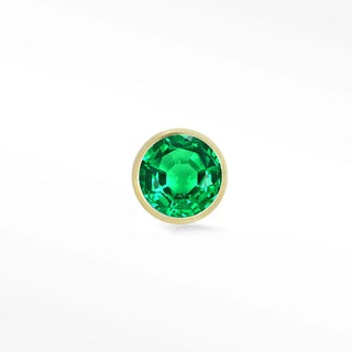 A vibrant green emerald stud earring set in a sleek 14k yellow gold flat bezel from the wynning studs collection