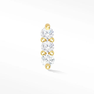 A delicate 14k yellow gold flat back earring with three clear stones and golden beads from wynning studs