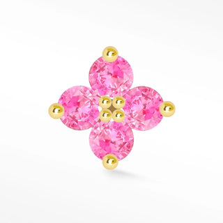 Delicate pink ruby stud earrings shaped like a flower with four faceted stones set in 14k gold clover frame