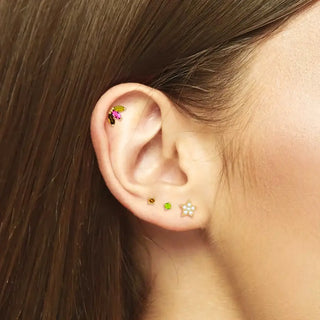 Delicate flatback gemstone stud earrings in 14k yellow gold with vibrant pink green gold floral and star designs wynning studs