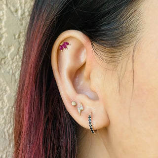 A delicate flat back earring in 14k gold featuring a pink sapphire 14k gemstone in a baby lotus design