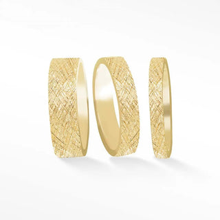 Three gold cigar band rings with a textured crosshatched pattern in florentine 14k gold band ring florentine style
