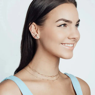A delicate 14k necklace in forged diamond gold with layered oval links and small dangling beads in rose gold