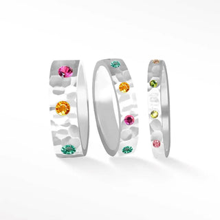 Set of three hammered silver tourmaline cigar band rings adorned with colorful pink orange green and yellow gemstones