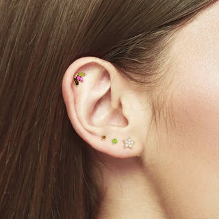 Gemstone earrings styled on an ear with other studs and hoops, view 3