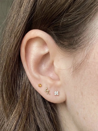 Gemstone earrings styled on an ear with other studs and hoops, view 4