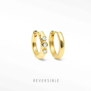 Telletubies gold hoop earrings in gold with one textured huggie hoop featuring three clear round stones by Wynning Reversible Hoops