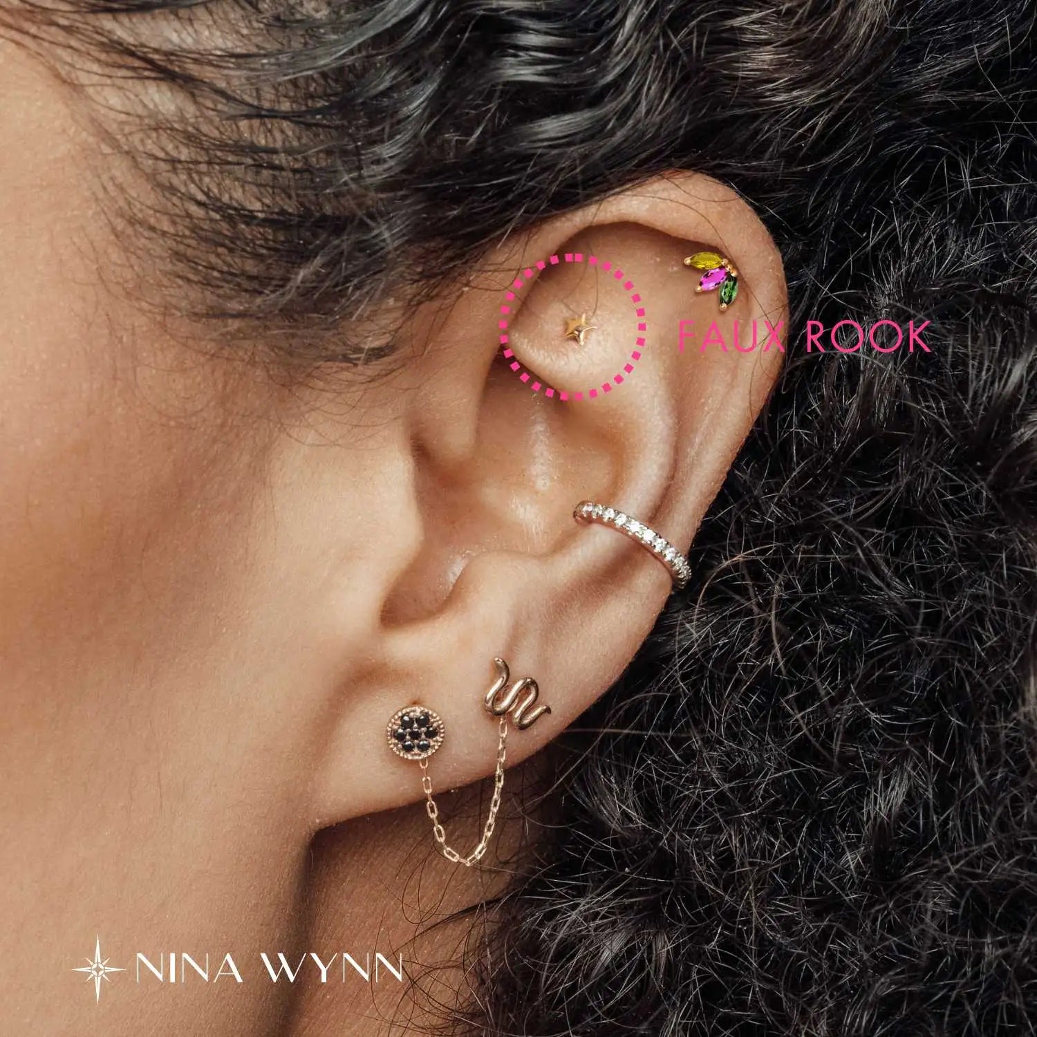 Faux rook piercing position located on the flat surface of the upper ear.