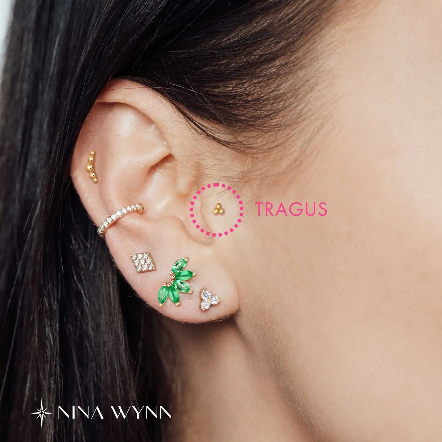 Tragus piercing placement on the small area of cartilage in front of the ear canal.