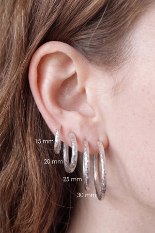 Hammered sterling silver hoop earrings in four sizes featuring textured silver hammered hoop design