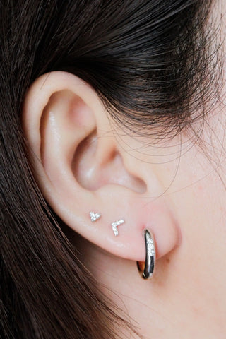 Silver two tone hoop earrings with embedded clear stones from Wynning reversible hoops collection