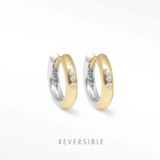 Two tone gold and silver hoop earrings with three clear stones each by Wynning reversible hoops