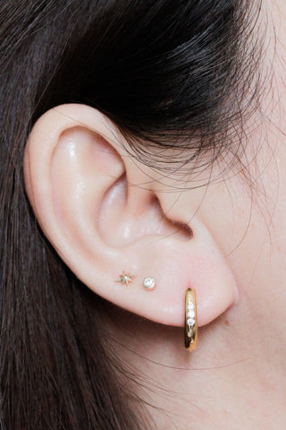 Gold hoop earrings with embedded diamonds from the two tone wynning reversible hoops collection